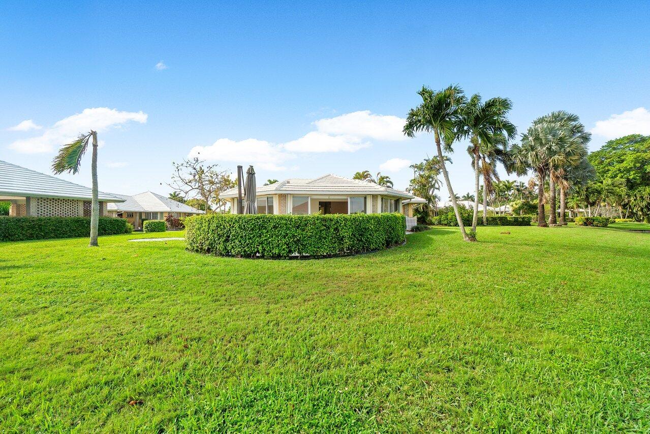 362 Yorktowne Circle Atlantis, FL 33462 - Photo 29 of 41 a view of a house with a big yard and potted plants