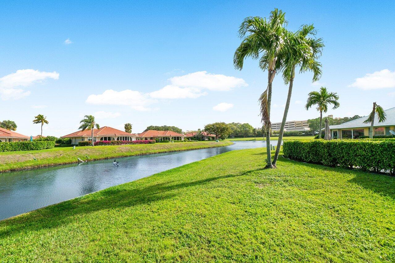 362 Yorktowne Circle Atlantis, FL 33462 - Photo 30 of 41 a view of a house with a yard and palm trees