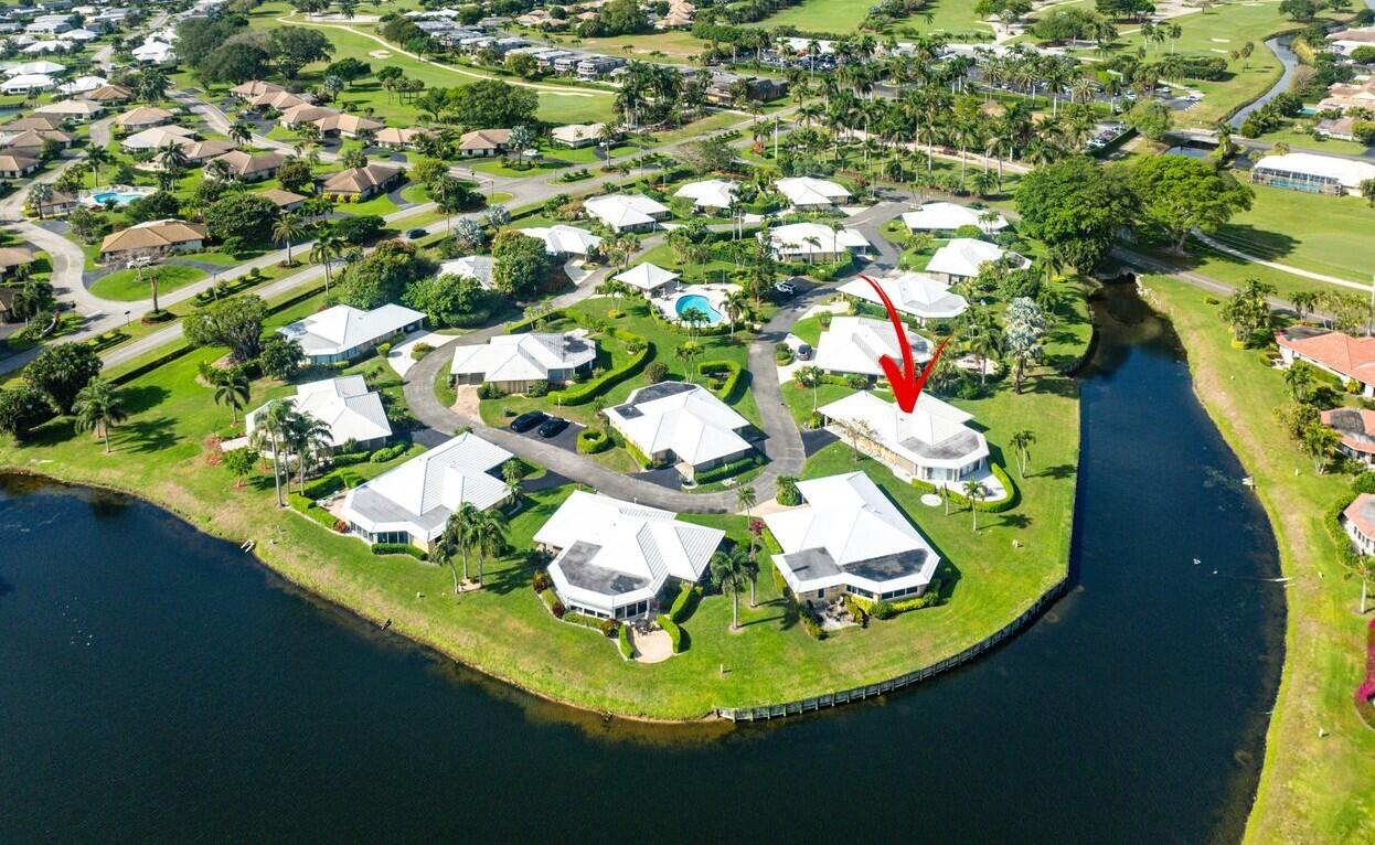 362 Yorktowne Circle Atlantis, FL 33462 - Photo 36 of 41 a view of a swimming pool with outdoor seating and garden