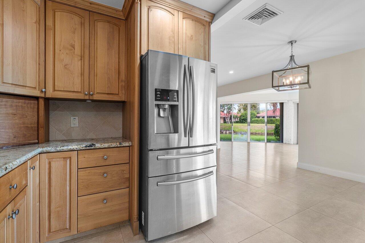 362 Yorktowne Circle Atlantis, FL 33462 - Photo 6 of 41 a kitchen with granite countertop stainless steel appliances a refrigerator and cabinets