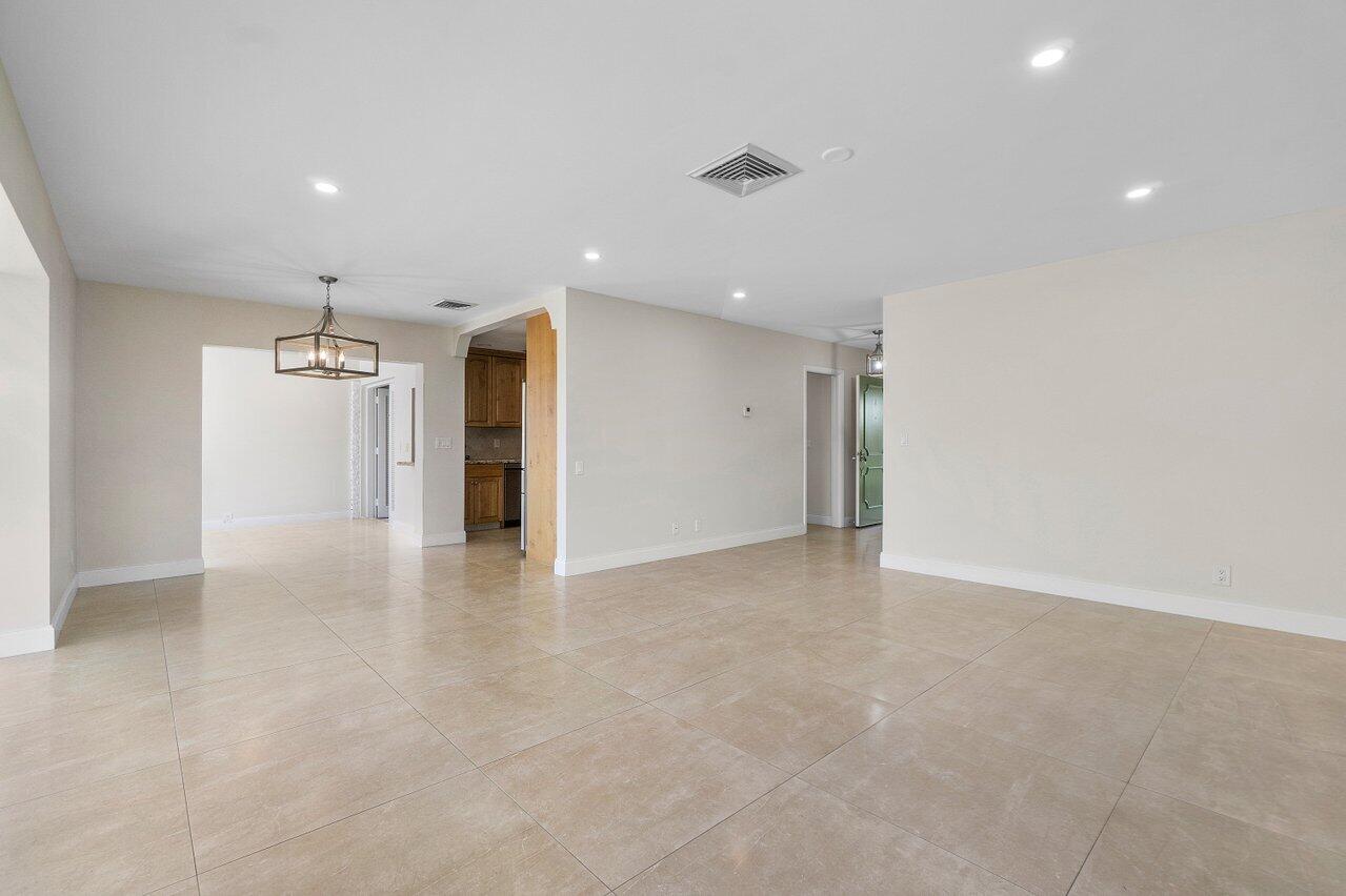 362 Yorktowne Circle Atlantis, FL 33462 - Photo 7 of 41 an empty room with an entryway and a chandelier fan