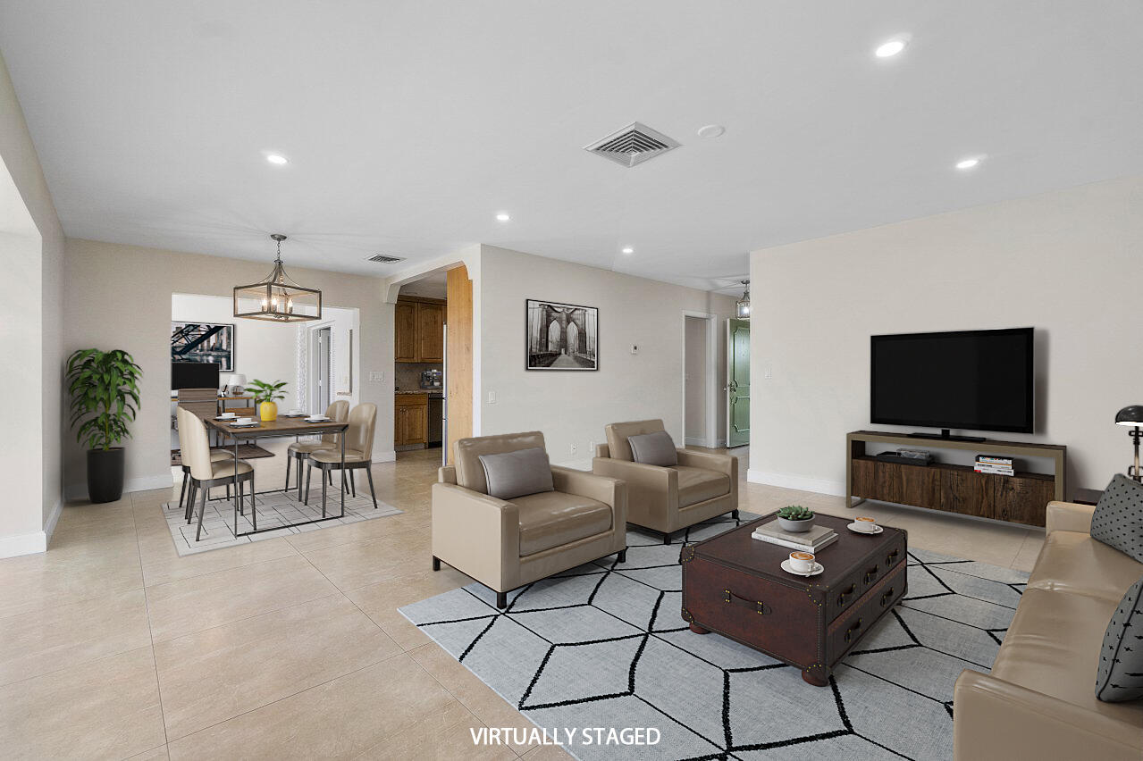 362 Yorktowne Circle Atlantis, FL 33462 - Photo 8 of 41 a living room with furniture and a flat screen tv