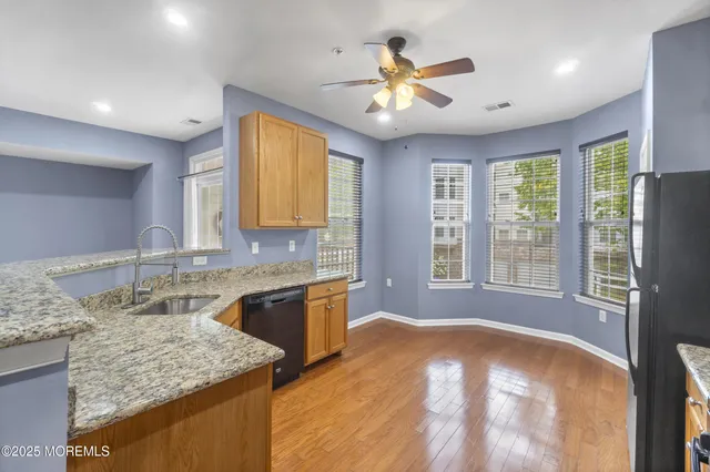 a bathroom with a granite countertop sink a bathtub and a large mirror