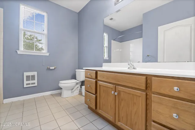 a bathroom with a sink mirror and toilet