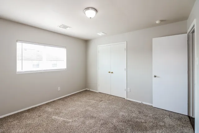 a view of an empty room with a window