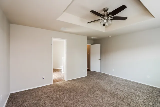 an empty room with a ceiling fan and a ceiling fan