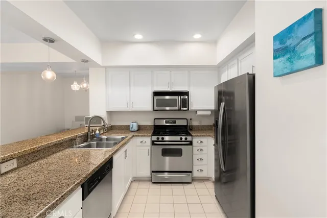 a kitchen with a sink stainless steel appliances and cabinets