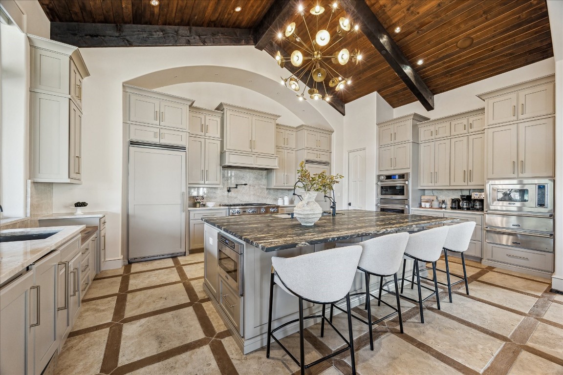 9 Rue Boerne, TX 78006 - Photo 21 of 50 a kitchen with stainless steel appliances kitchen island granite countertop a sink and cabinets