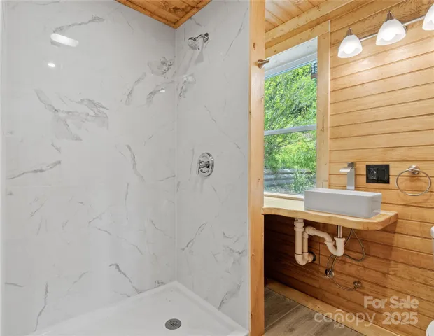 a bathroom with a shower and a tub