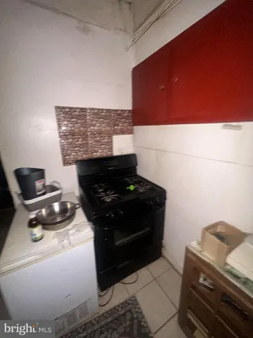 a stove top oven sitting inside of a kitchen