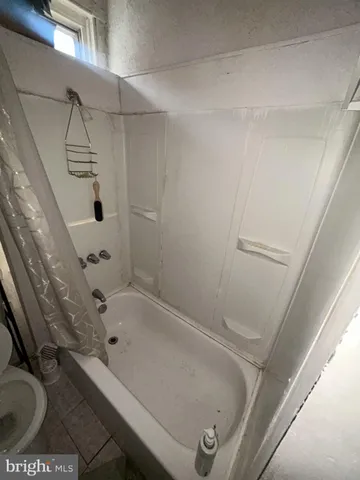 a bathroom with a tub and shower