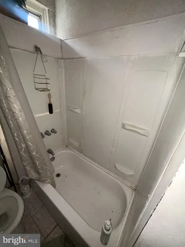 a bathroom with a tub and shower