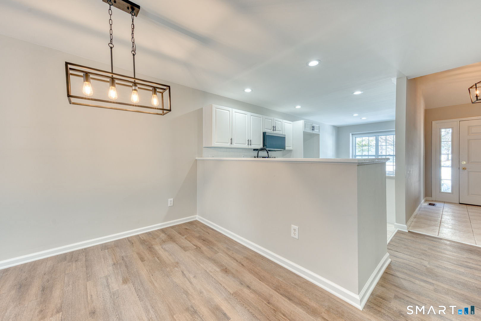 159 Jennifer Lane, Unit 159 Newtown, CT 06482 - Photo 9 of 28 a view of a kitchen with wooden floor and a window