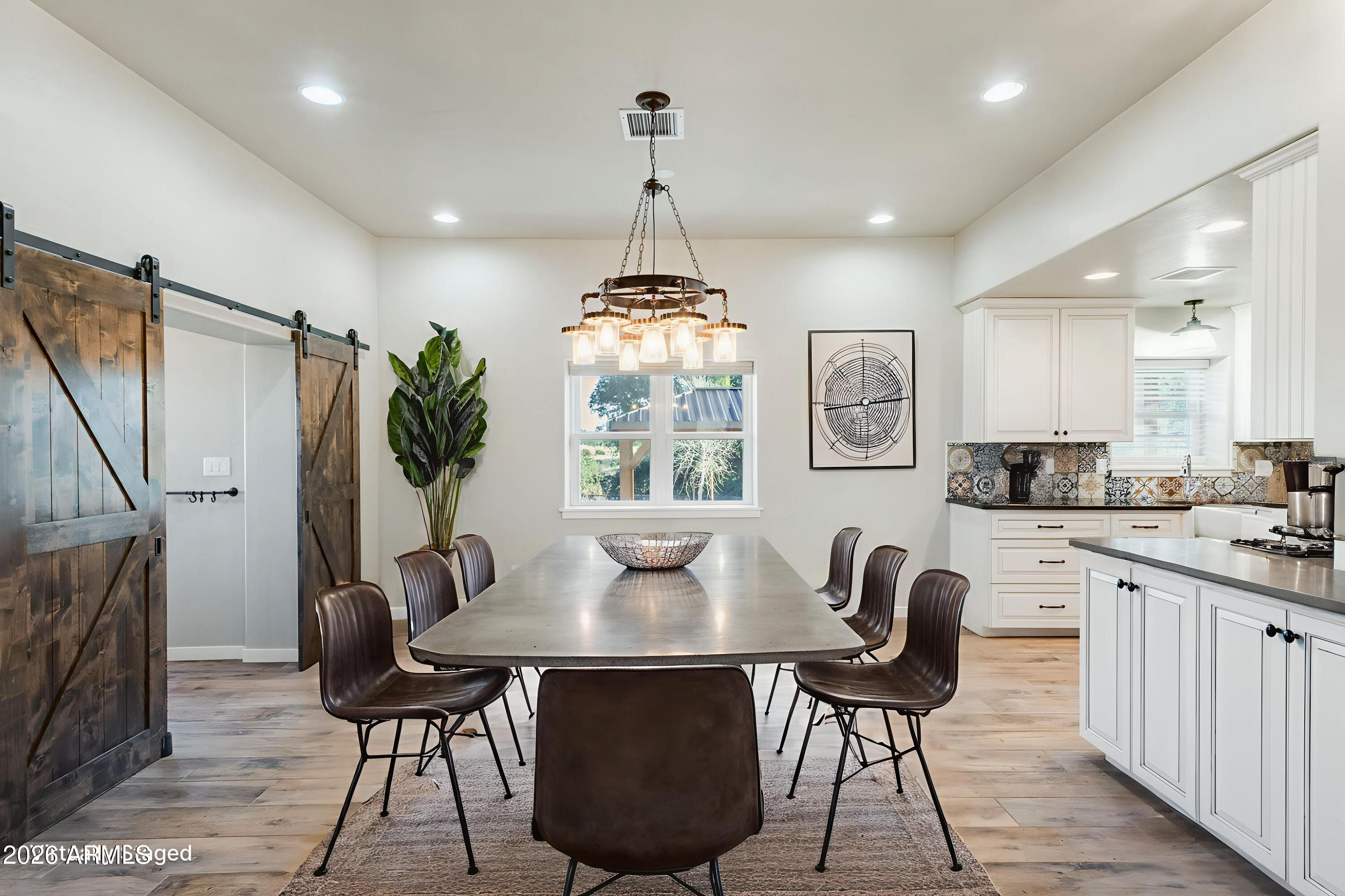 5306 East Spring Road Hereford, AZ 85615 - Photo 13 of 61 a dining room with furniture a chandelier and wooden floor