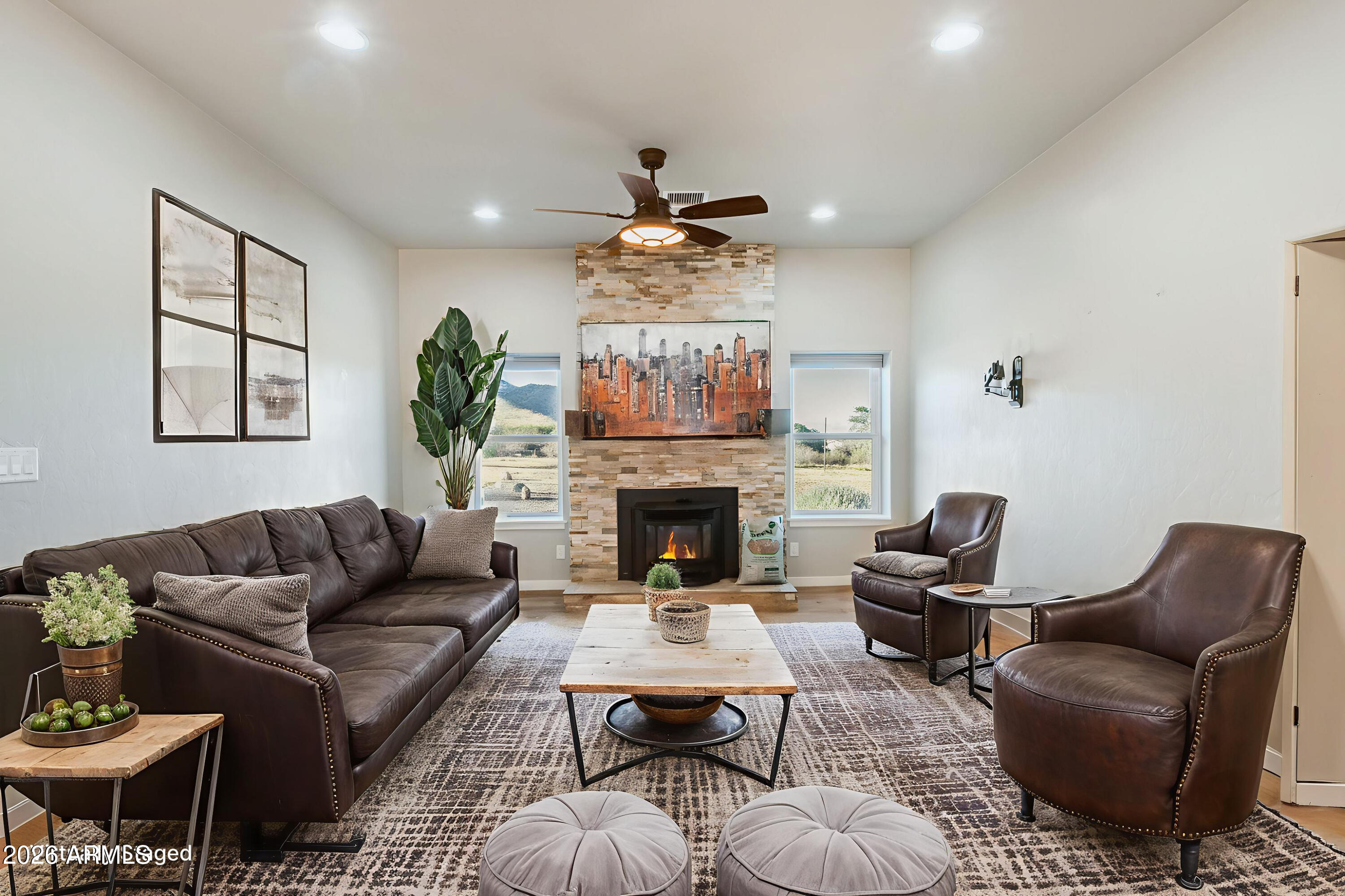 5306 East Spring Road Hereford, AZ 85615 - Photo 15 of 61 a living room with furniture a fireplace and a flat screen tv