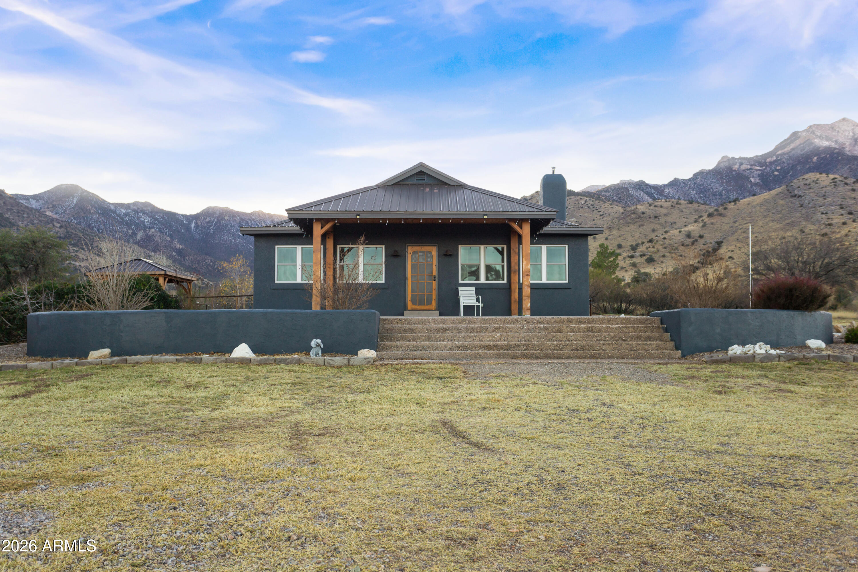 5306 East Spring Road Hereford, AZ 85615 - Photo 2 of 61 a front view of a house with a yard