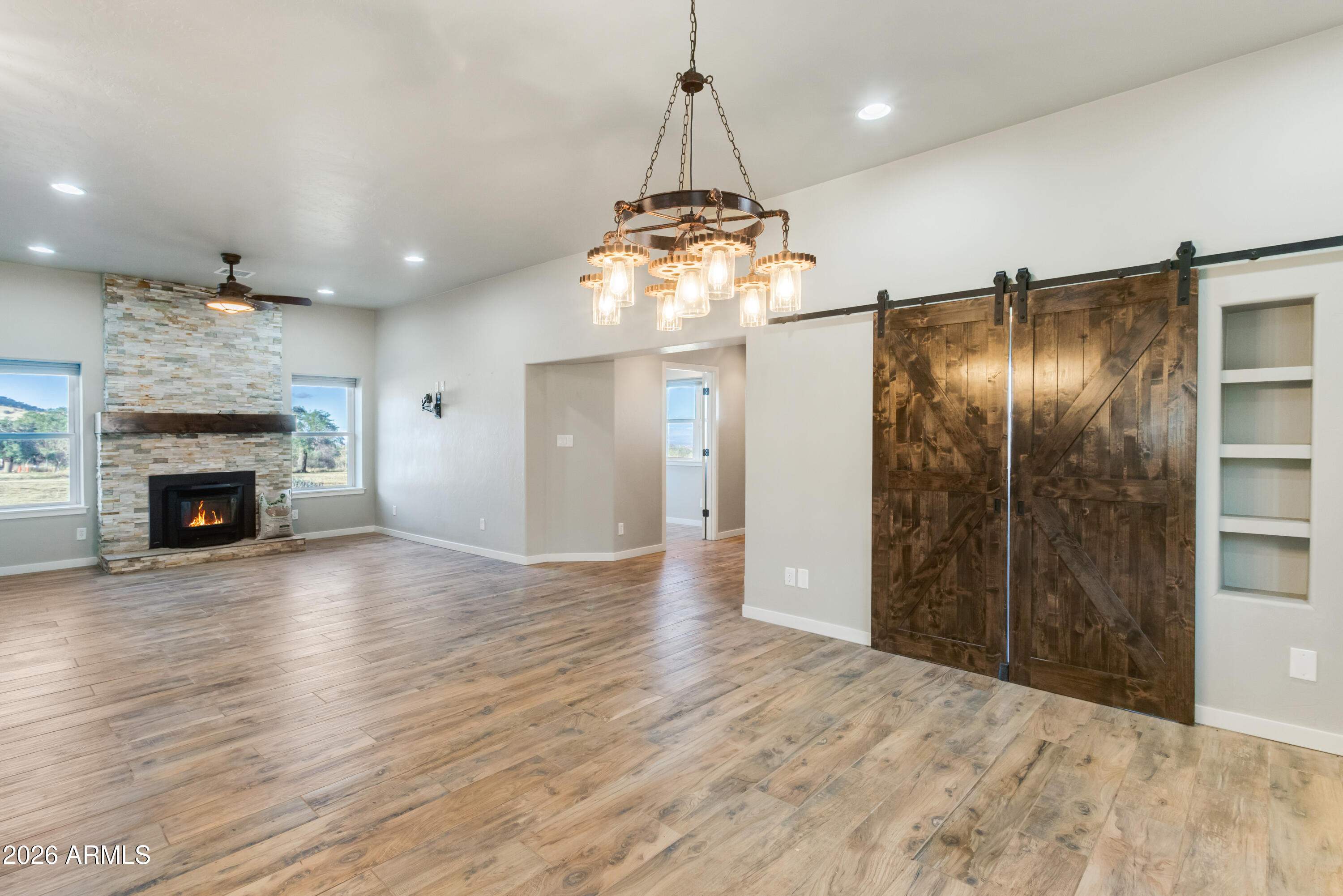 5306 East Spring Road Hereford, AZ 85615 - Photo 21 of 61 a view of a livingroom with a chandelier and fireplace