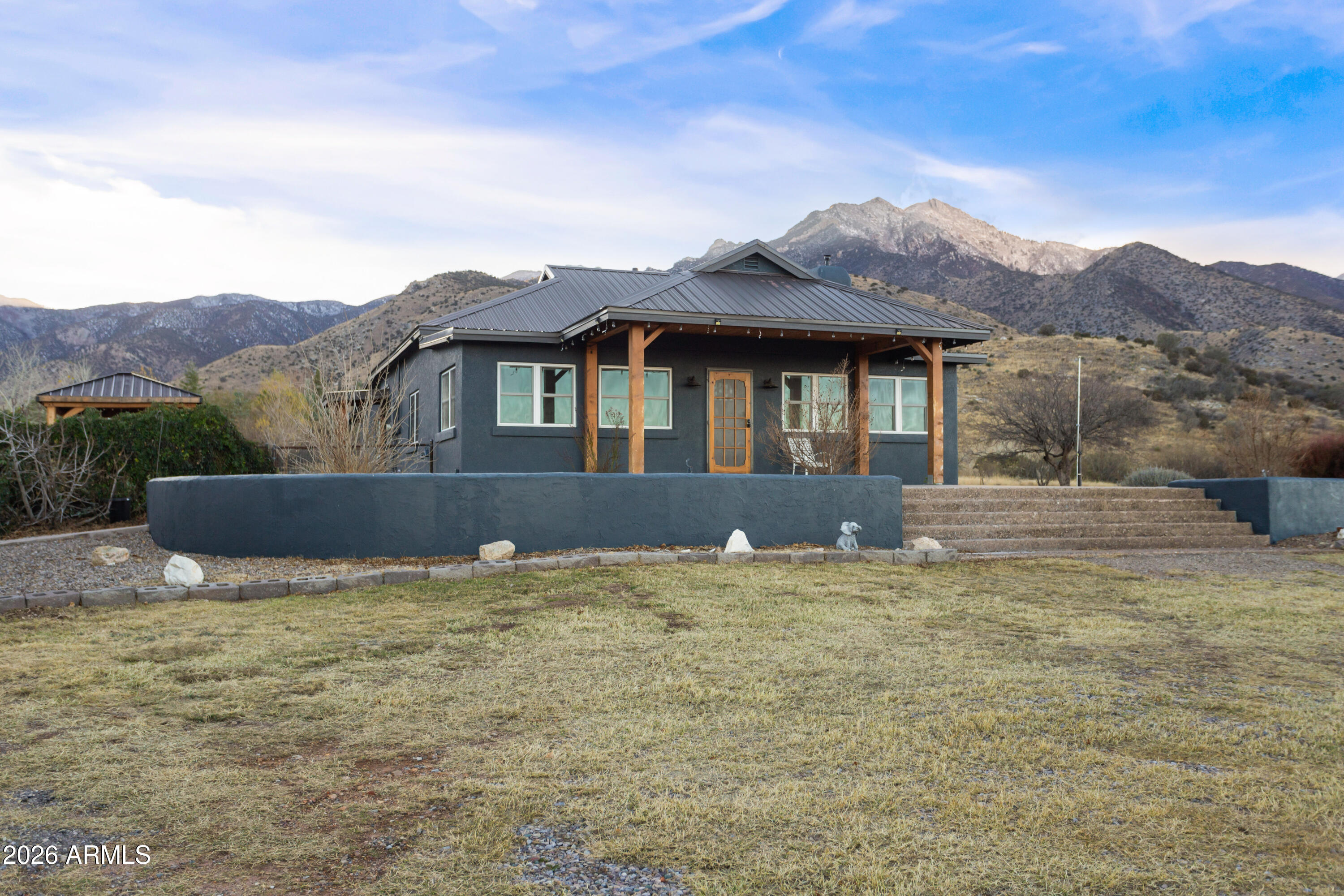 5306 East Spring Road Hereford, AZ 85615 - Photo 3 of 61 a front view of a house with a yard