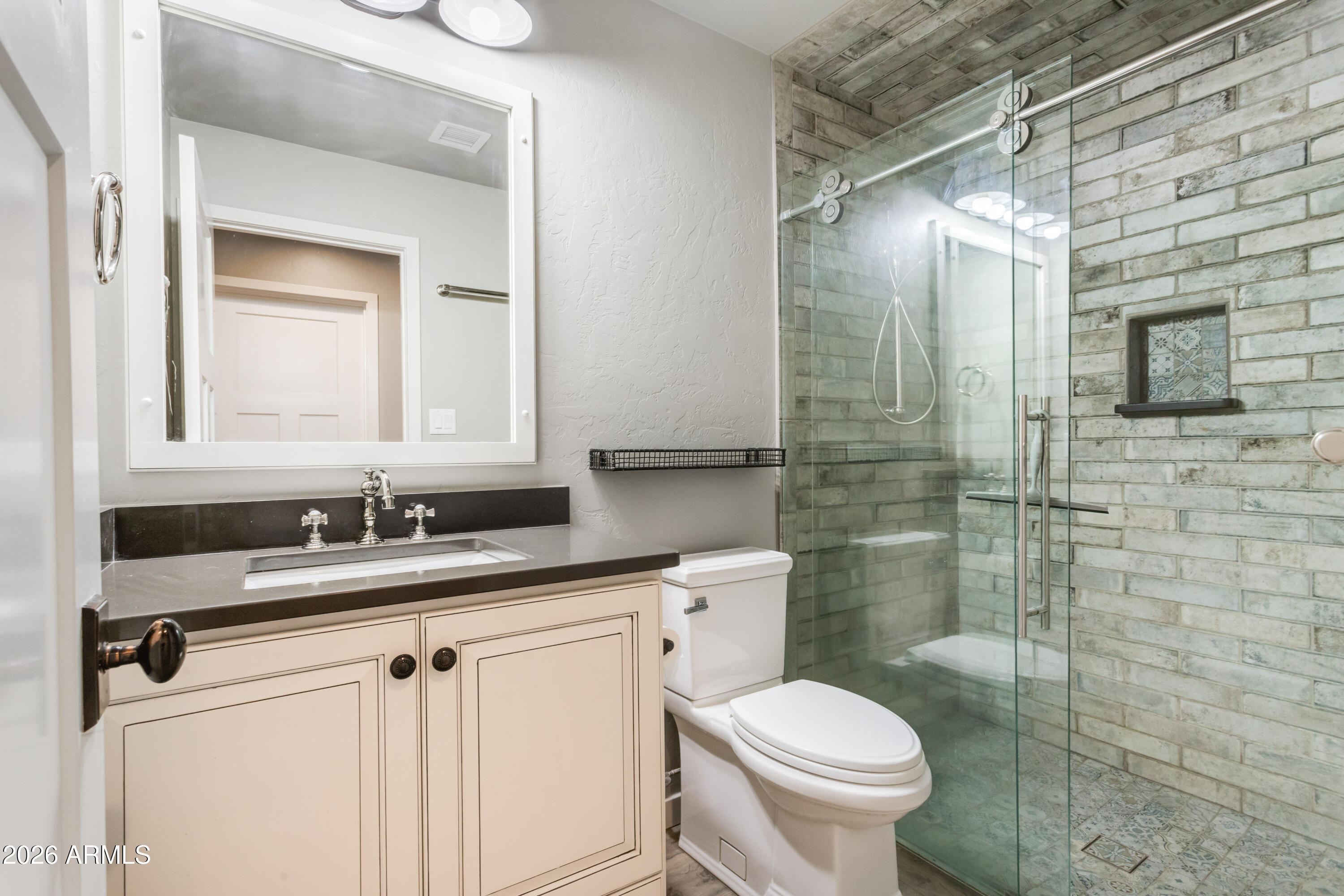 5306 East Spring Road Hereford, AZ 85615 - Photo 34 of 61 a bathroom with a granite countertop toilet sink and mirror