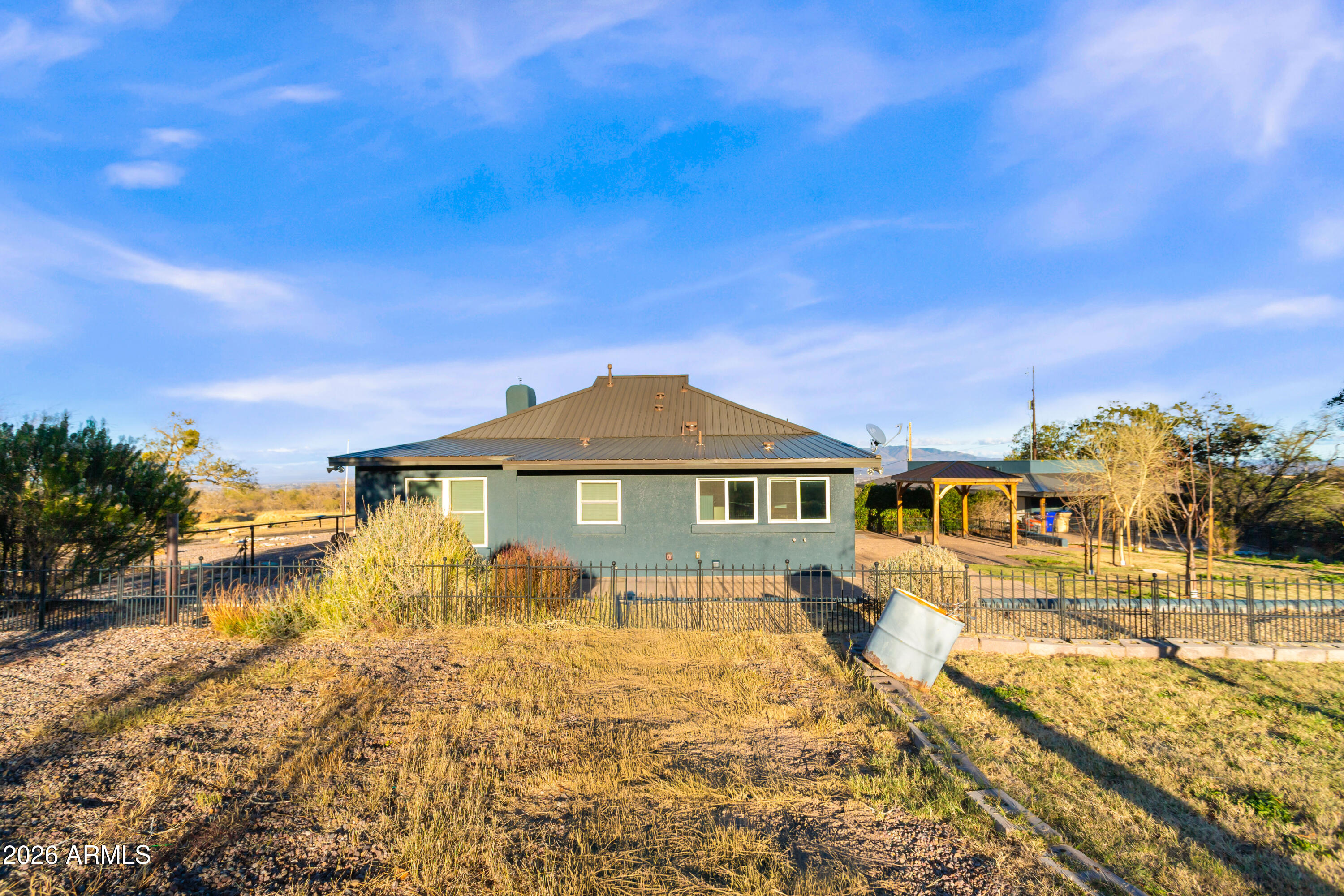 5306 East Spring Road Hereford, AZ 85615 - Photo 39 of 61 a front view of a house with a yard