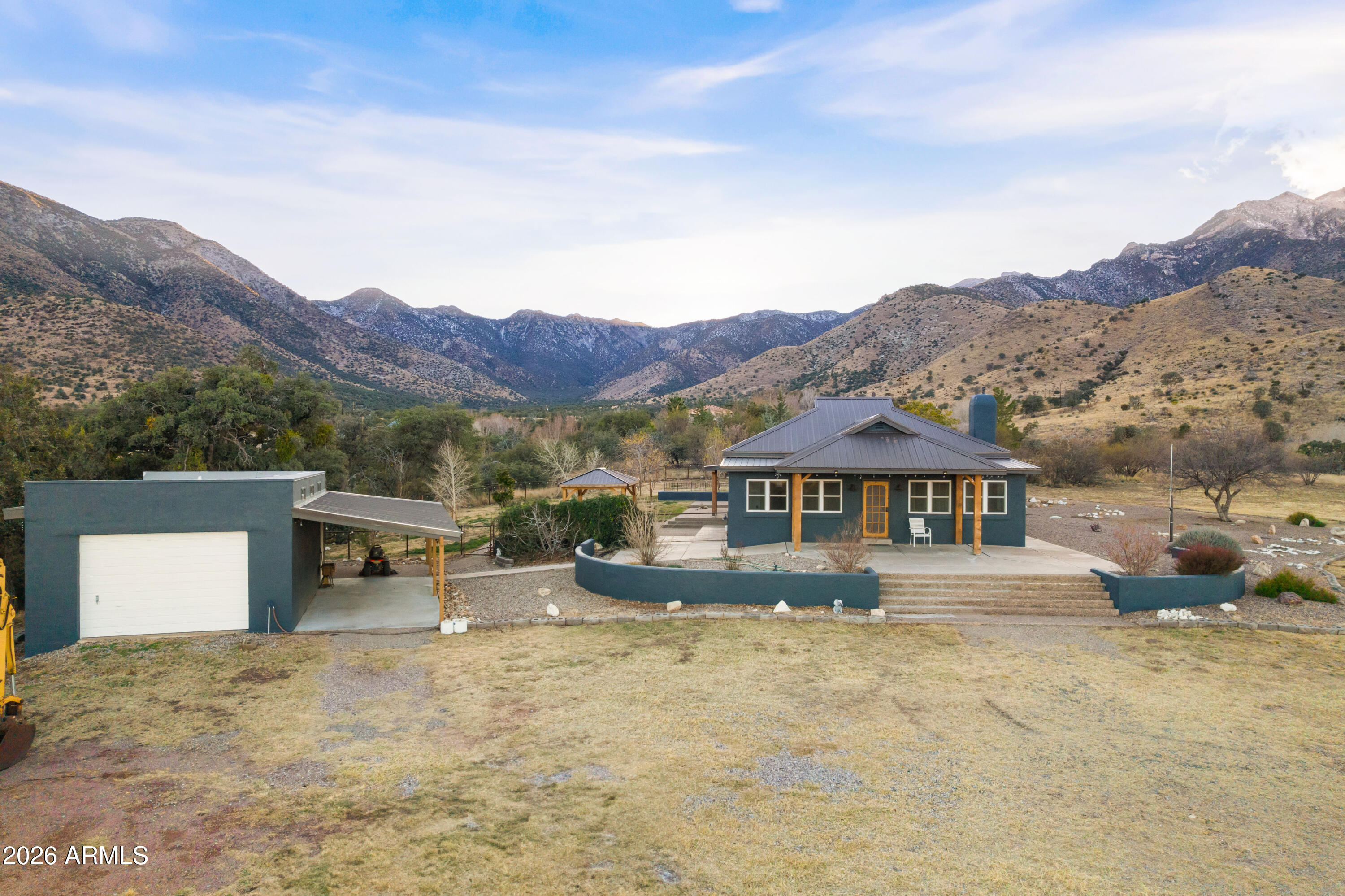 5306 East Spring Road Hereford, AZ 85615 - Photo 52 of 61 a view of a house with a yard and a large tree
