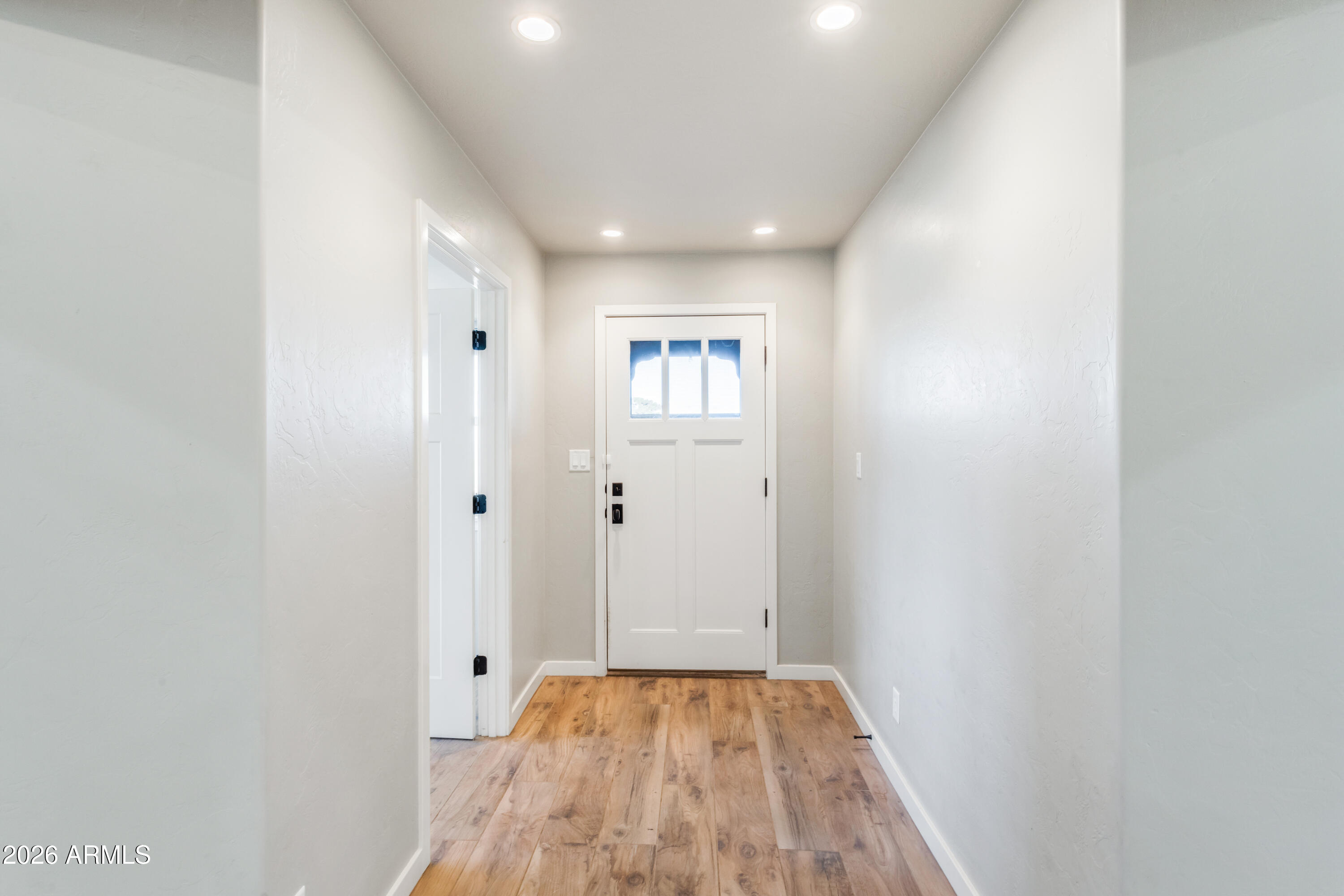 5306 East Spring Road Hereford, AZ 85615 - Photo 6 of 61 a view of a hallway with wooden floor