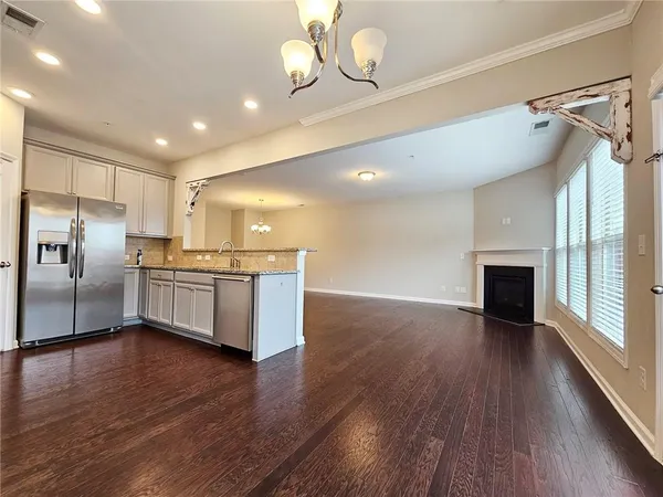 a kitchen with stainless steel appliances a refrigerator and a fireplace