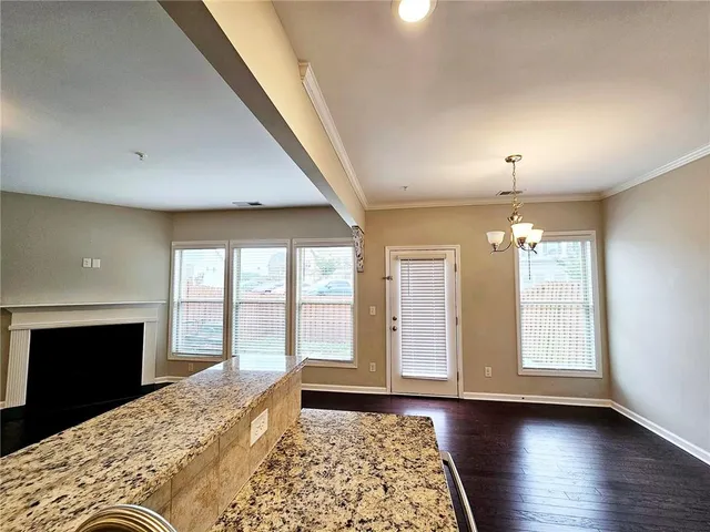 a view of an empty room with a fireplace and a window