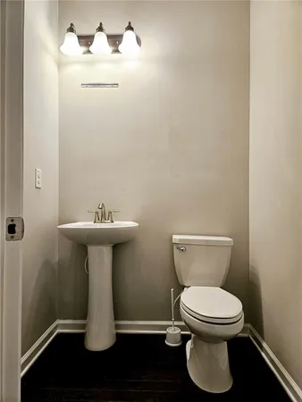 a white toilet sitting next to a bathroom sink
