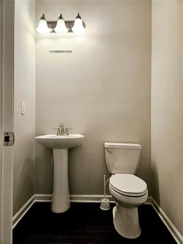 a white toilet sitting next to a bathroom sink