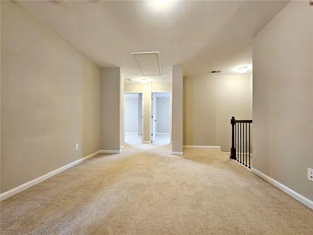 a view of empty room with a bathroom