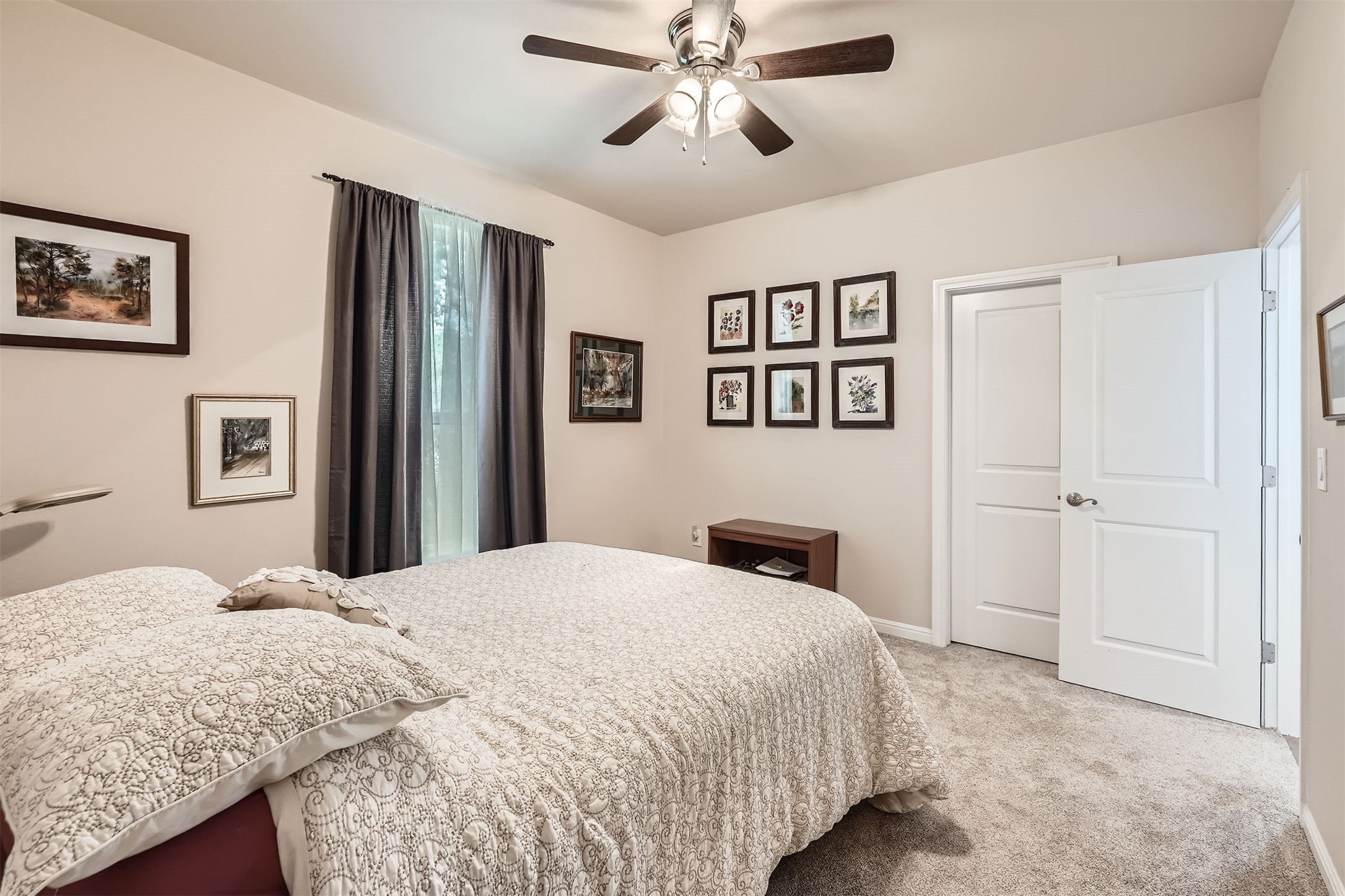5501 Hitching Post Lago Vista, TX 78645 - Photo 23 of 26 a bedroom with a large bed and a chandelier