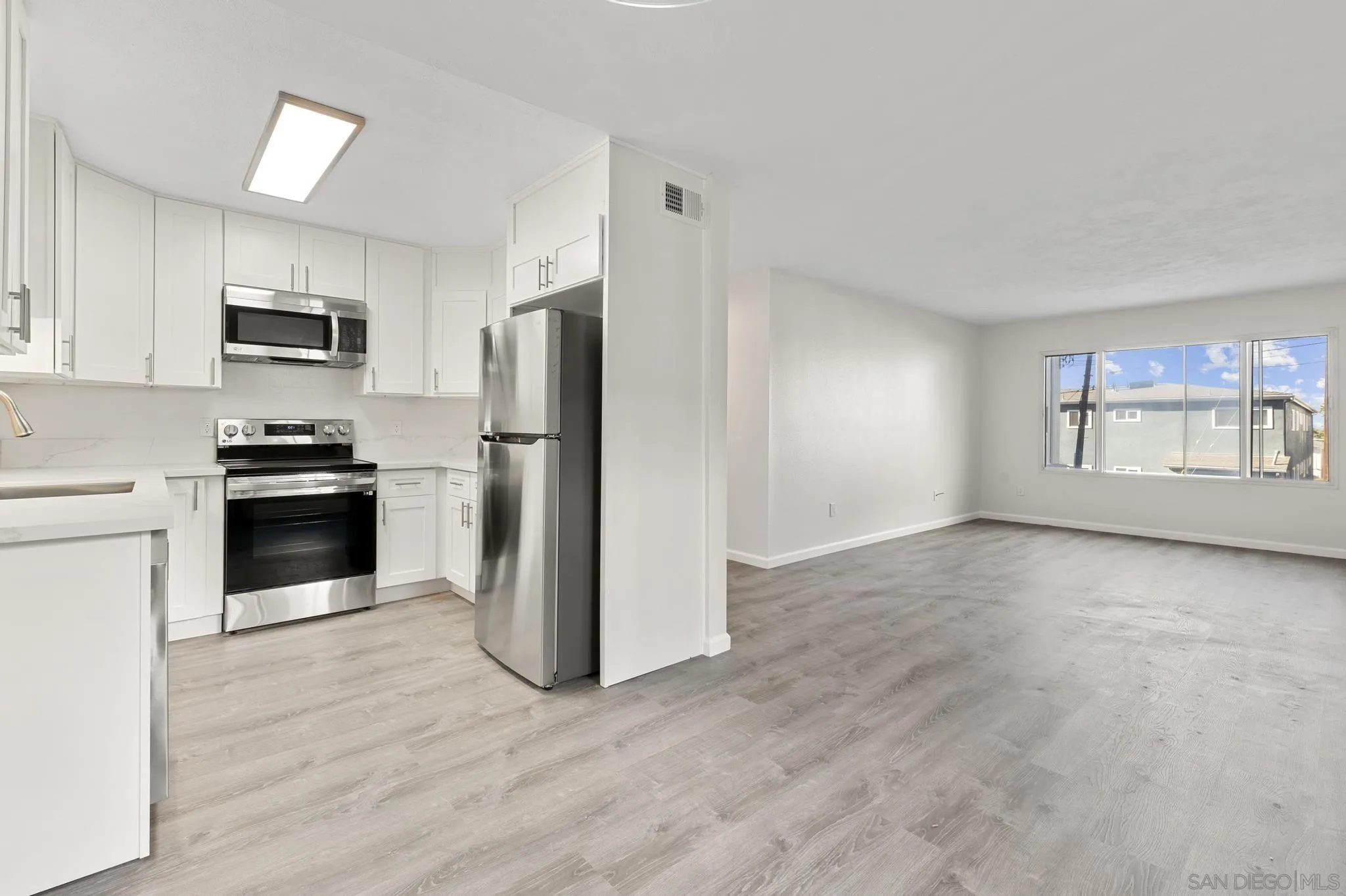 140 Walnut Avenue, Unit 2A San Diego, CA 92103 - Photo 1 of 22 a kitchen with stainless steel appliances a refrigerator and a stove top oven