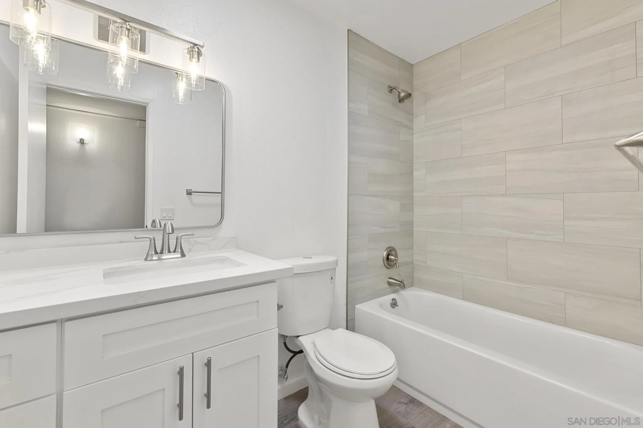 140 Walnut Avenue, Unit 2A San Diego, CA 92103 - Photo 15 of 22 a bathroom with a sink toilet vanity and shower