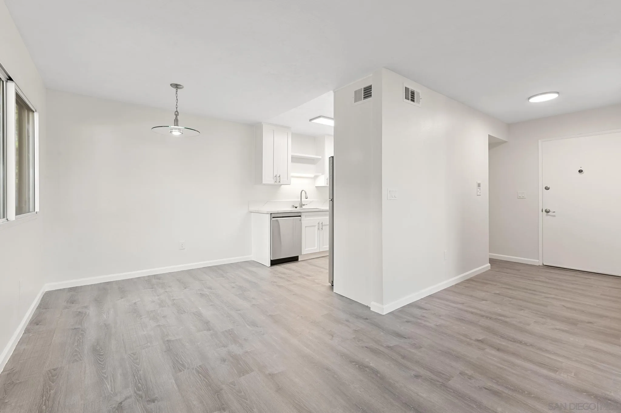 140 Walnut Avenue, Unit 2A San Diego, CA 92103 - Photo 5 of 22 a view of a kitchen with wooden floor and a sink
