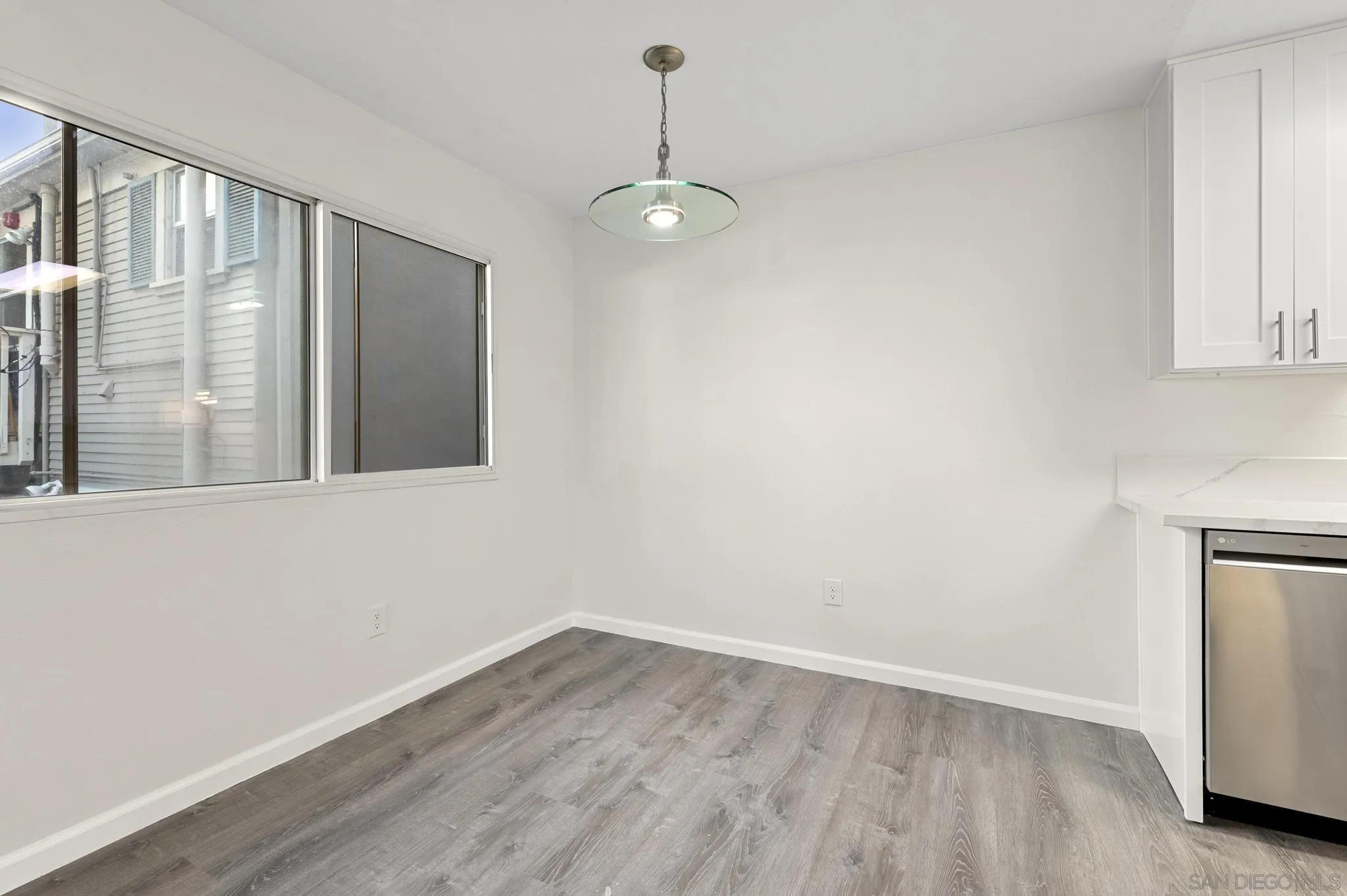 140 Walnut Avenue, Unit 2A San Diego, CA 92103 - Photo 6 of 22 a view of an empty room with wooden floor and a window