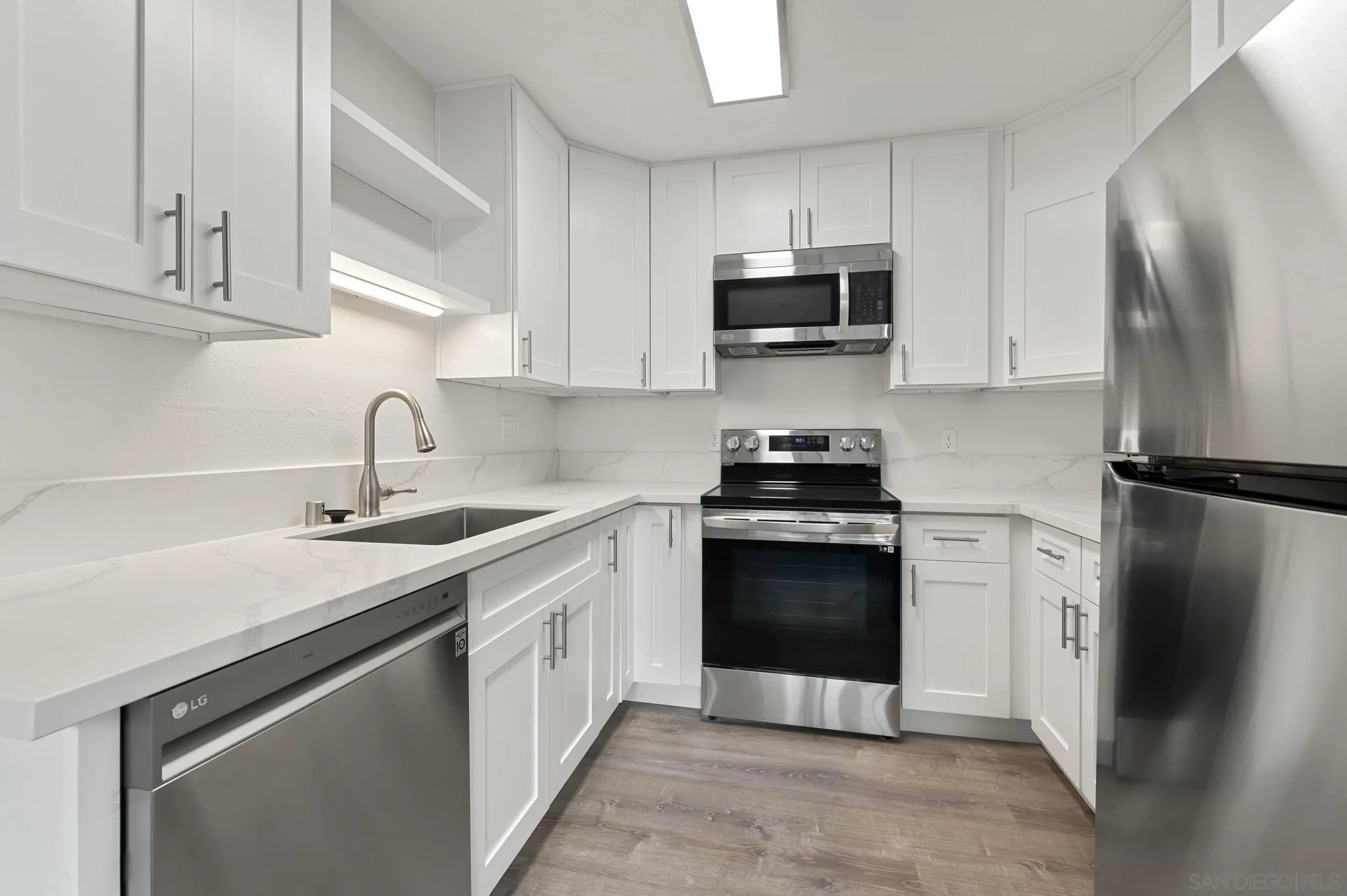 140 Walnut Avenue, Unit 2A San Diego, CA 92103 - Photo 7 of 22 a kitchen with cabinets stainless steel appliances and a sink