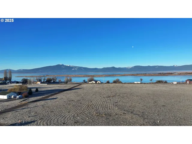 a open area with lake view and mountain in the back