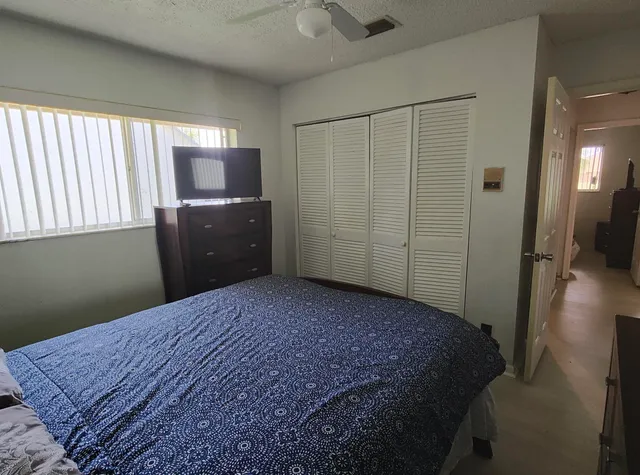 a bedroom with a bed dresser and a window