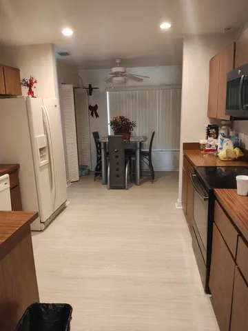 a kitchen with stainless steel appliances a refrigerator and a stove top oven