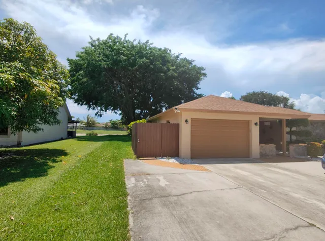 a front view of a house with yard and a garage