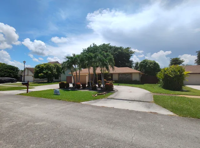 a view of a park with large trees and a big yard