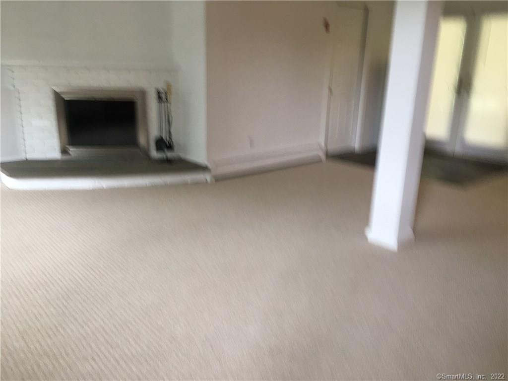 17 Cottontail Road Norwalk, CT 06854 - Photo 8 of 10 a view of an empty room with a fireplace and a window
