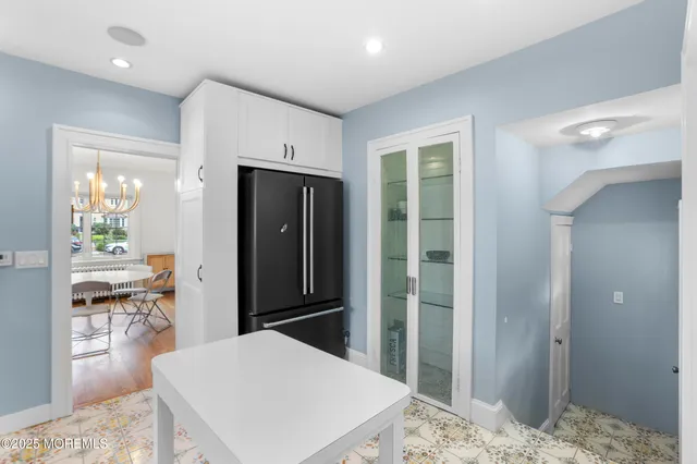 a kitchen with stainless steel appliances kitchen island granite countertop a refrigerator and cabinets