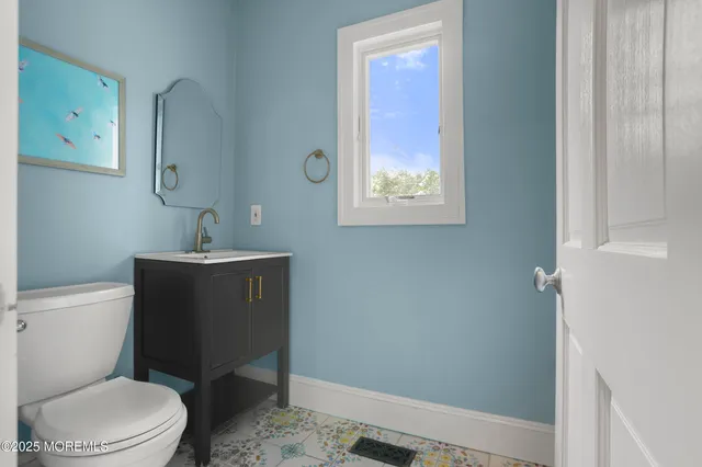 a bathroom with a toilet a sink and mirror