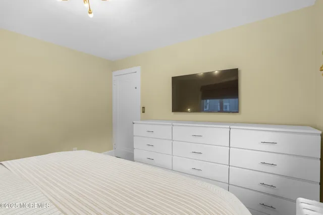 a bedroom with a bed and a television