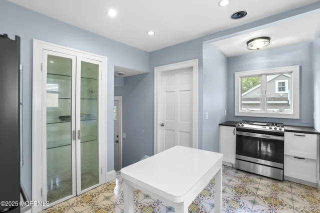 a kitchen with a stove a sink and a refrigerator