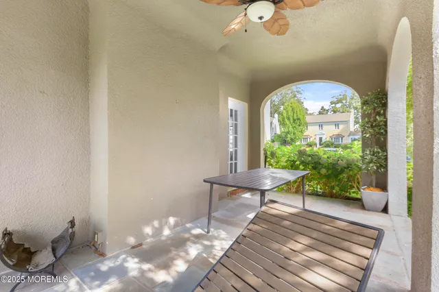 a view of a room with a wooden floor and a potted plant