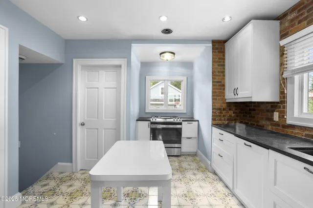 a kitchen with cabinets and window