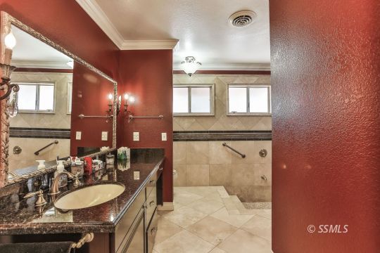 1509 Welcome Way Ridgecrest, CA 93555 - Photo 34 of 50 a bathroom with a granite countertop sink a mirror and a shower